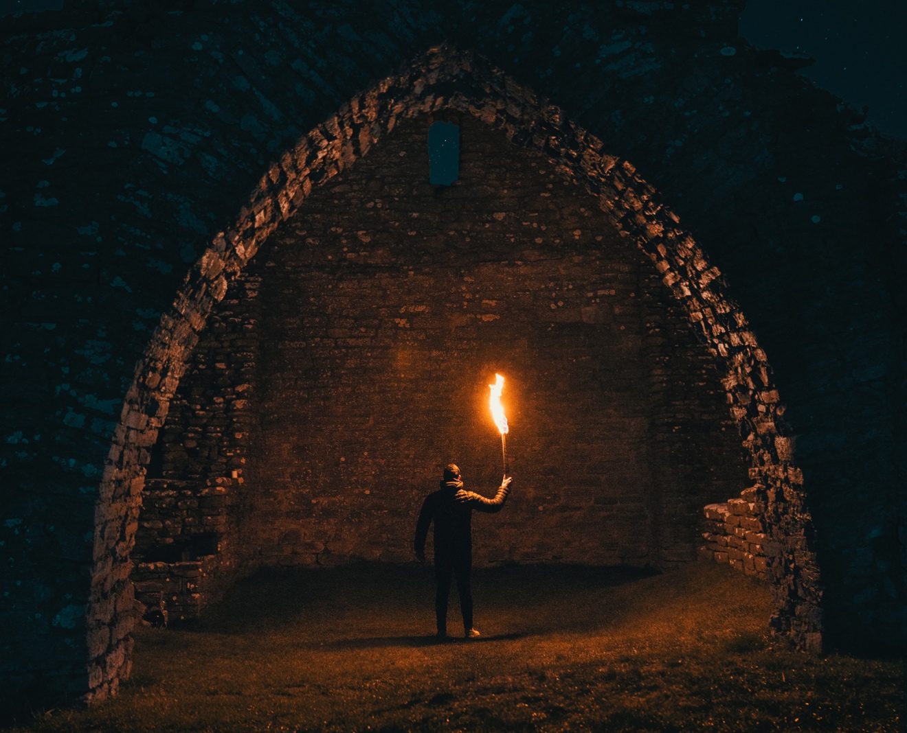 man with torch in tunnel