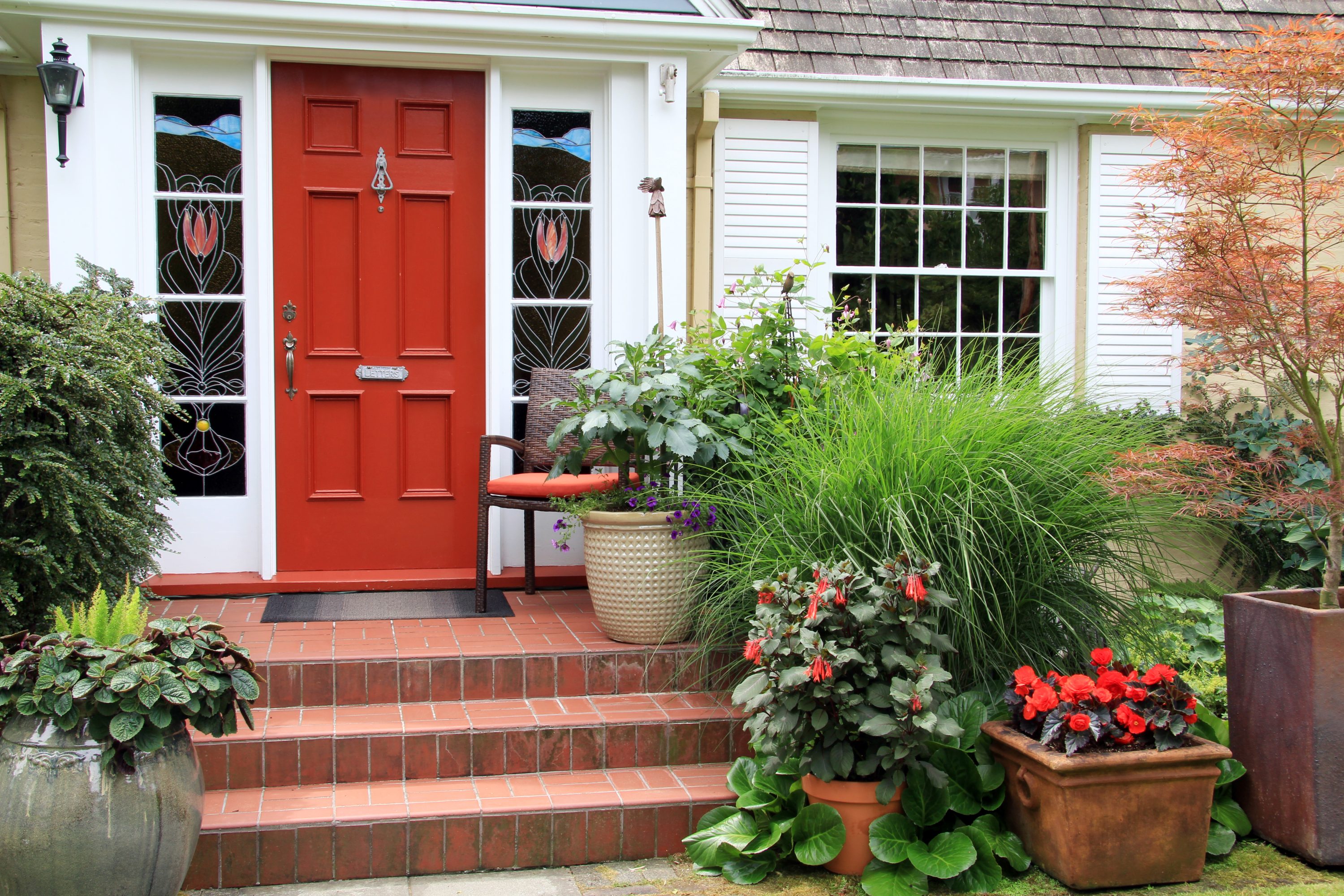 red front door with plants
