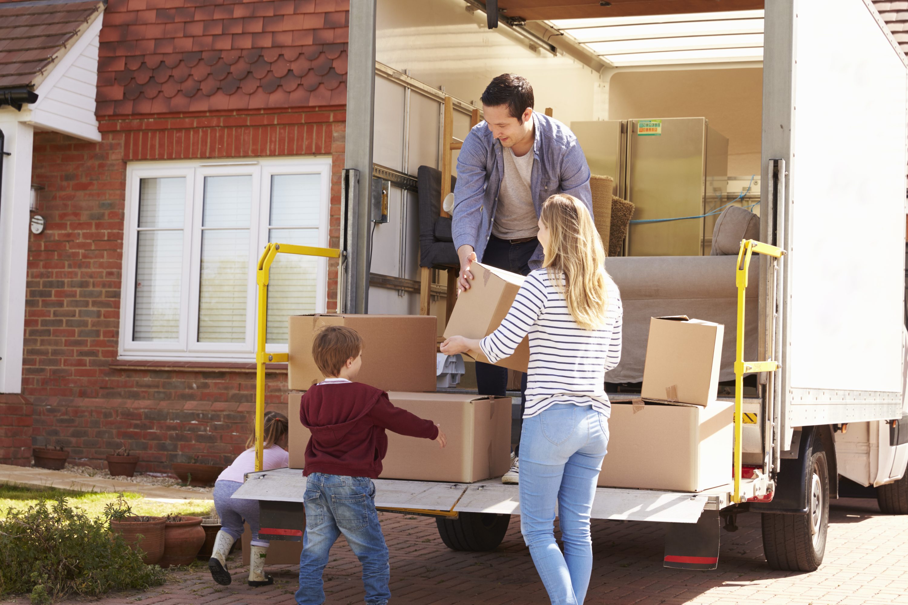 family unloading moving truck